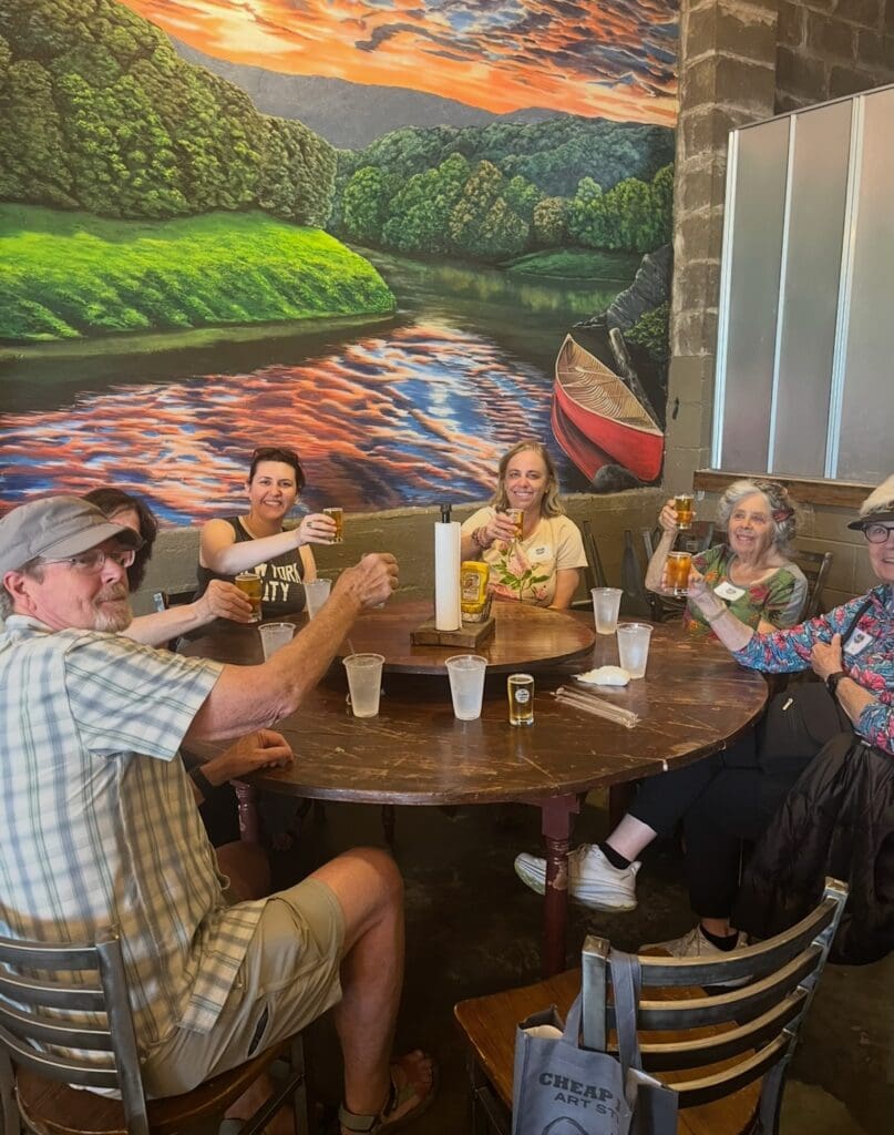 Tour guests toasting with drinks at a local restaurant